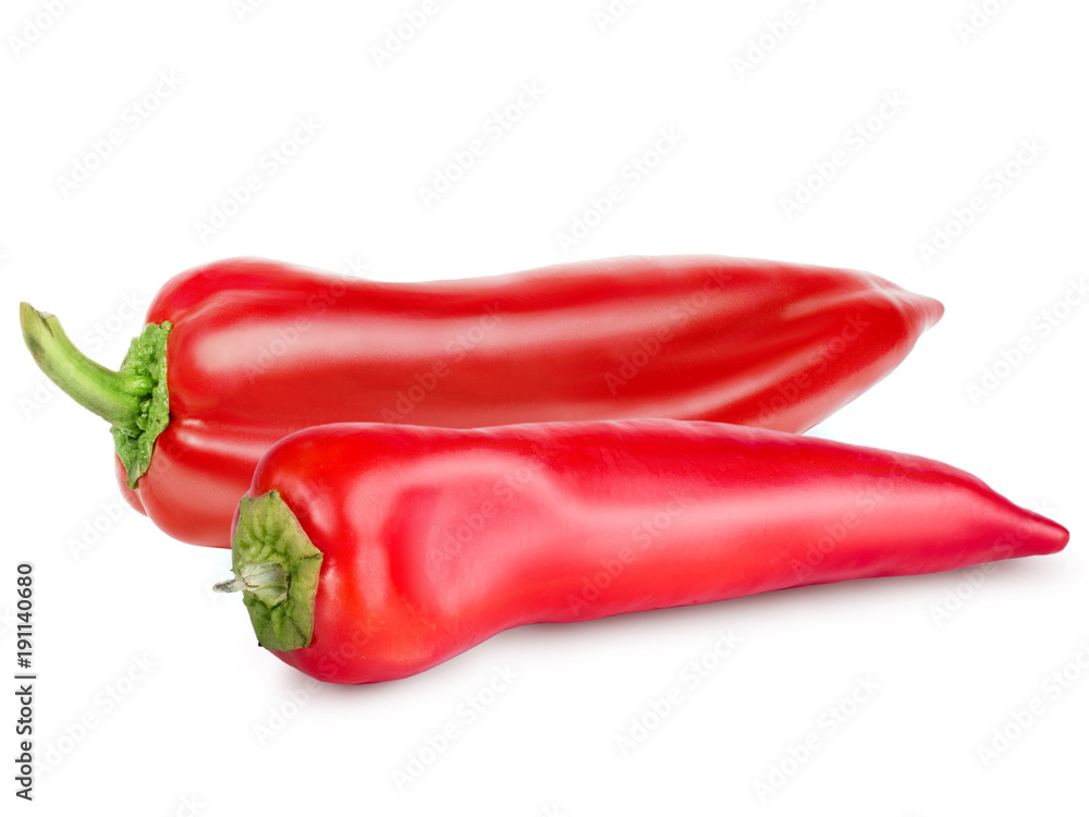 Two bright red peppers with green tail isolated on white background. Retouched peppers with texture, glare and shadow. Close-up view, objects turned to the left.