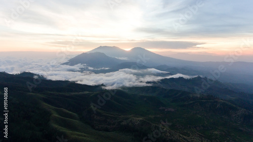 Beautiful sunset in the mountains on Jawa island  Indonesia. Aerial view of mountains landscape under sky with clouds  rainforest.