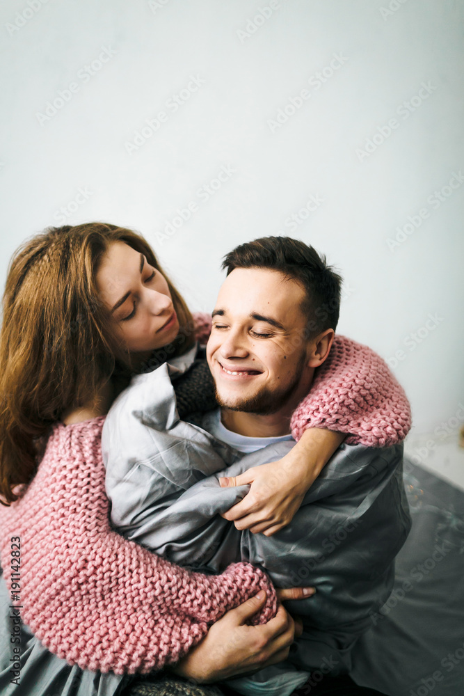 Cute Young Woman Embracing and Kiss Her Boyfriend. A couple having fun in the bed. Artwork. Soft focus Cute Young Woman Embracing and Kiss Her Boyfriend. A couple having fun in the bed. Artwork. Soft focus