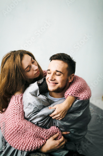 Cute Young Woman Embracing and Kiss Her Boyfriend. A couple having fun in the bed. Artwork. Soft focus © stakhov