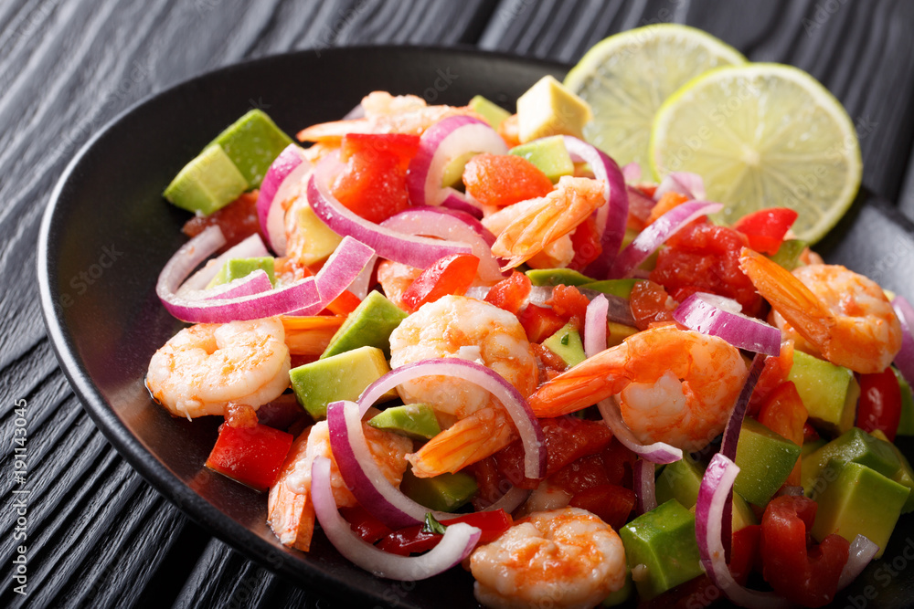 Spicy shrimp ceviche with vegetable salsa close-up on a plate on a table. horizontal Spicy shrimp ceviche with vegetable salsa close-up on a plate on a table. horizontal