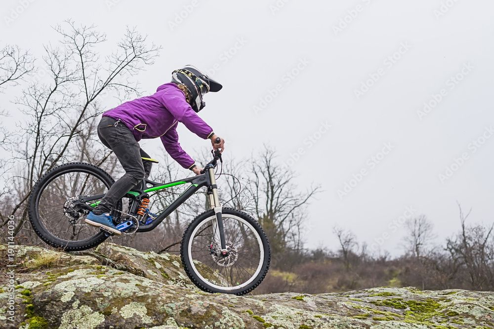 Enduro Cyclist Riding the Mountain Bike on the Rocky Trail, copy of free space. Enduro Cyclist Riding the Mountain Bike on the Rocky Trail, copy of free space.