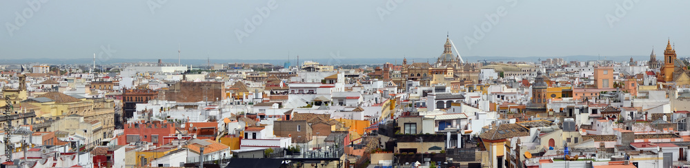 A spring May sky over Spanish Seville old town  roofs.