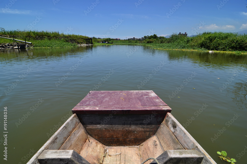 Rowing boat boat cruising along a calm blue river Rowing boat boat cruising along a calm blue river