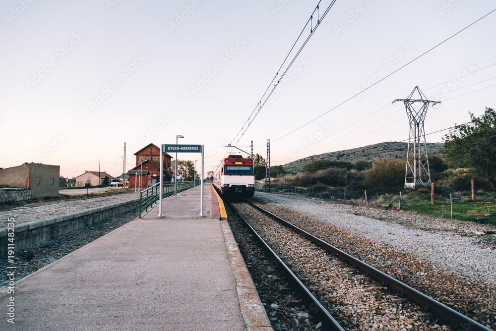 Train at old railroad station platform in countryside at sunset Train at old railroad station platform in countryside at sunset