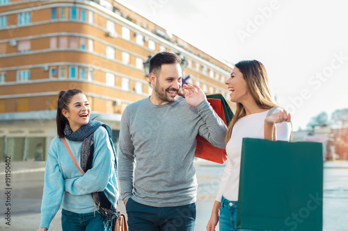 Happy friends shopping. Young friends enjoying shopping in the city.