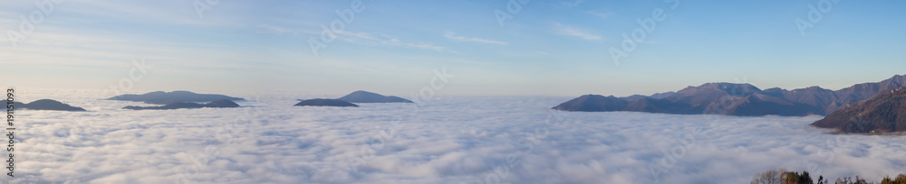 Fototapeta premium Drone aerial view to the Po plain and Seriana valley. The fog covers all the villages and the Padana plain