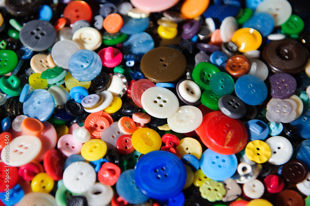 Lot of colorful plastic clothing buttons. Many small round vintage buttons pattern background Lot of colorful plastic clothing buttons. Many small round vintage buttons pattern background