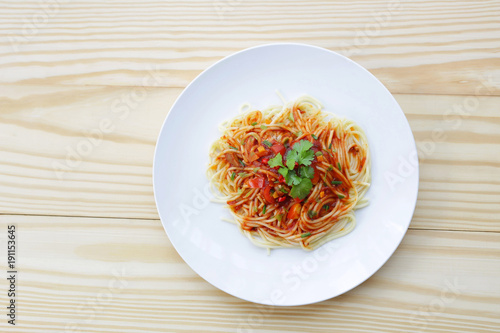 Simple Spaghetti in white plate on wooden table
