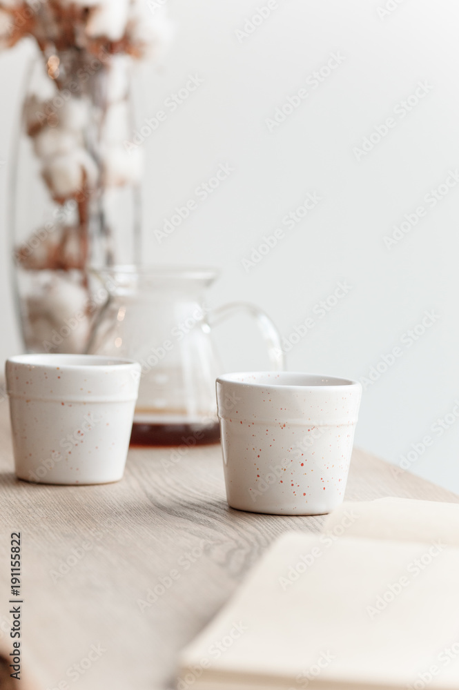 Cup of coffee, branch of tree, wooden windowsill Cup of coffee, branch of tree, wooden windowsill