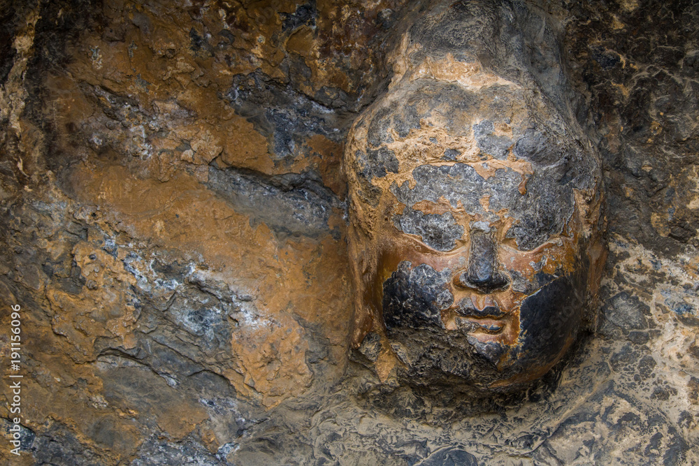 Close-up The face Stone Buddha Statue Carved from the mountains. Close-up The face Stone Buddha Statue Carved from the mountains.