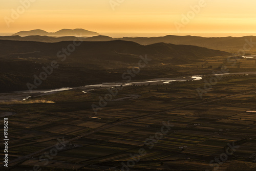 Evening mood panorama taken from Byllis village - Aerial view of landscape with fields, river band and mountains in the background, Byllis,north-east of Vlore in Fier Country, Albania, Europe photo