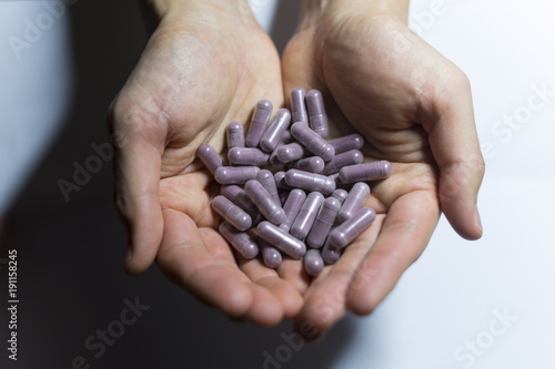 lot of pupple pill in hand