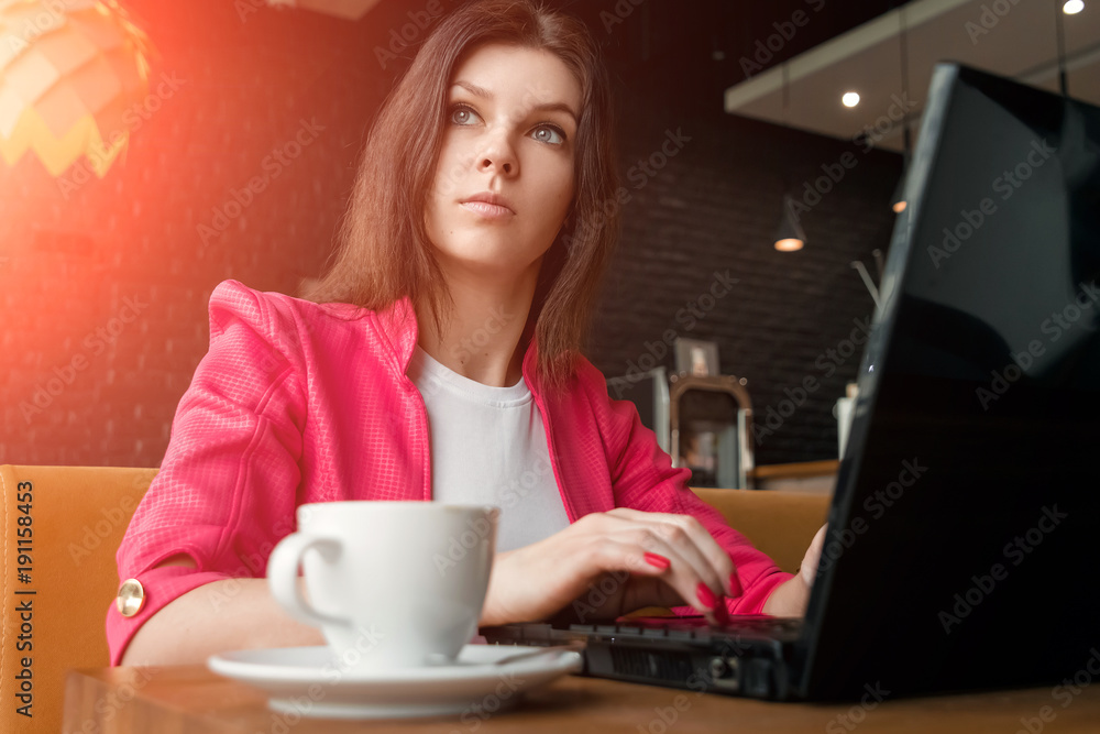 Young, beautiful girl, businesswoman, sitting in cafe and working on laptop. business lunch, cup of coffee, successful business woman. Young, beautiful girl, businesswoman, sitting in cafe and working on laptop. business lunch, cup of coffee, successful business woman.