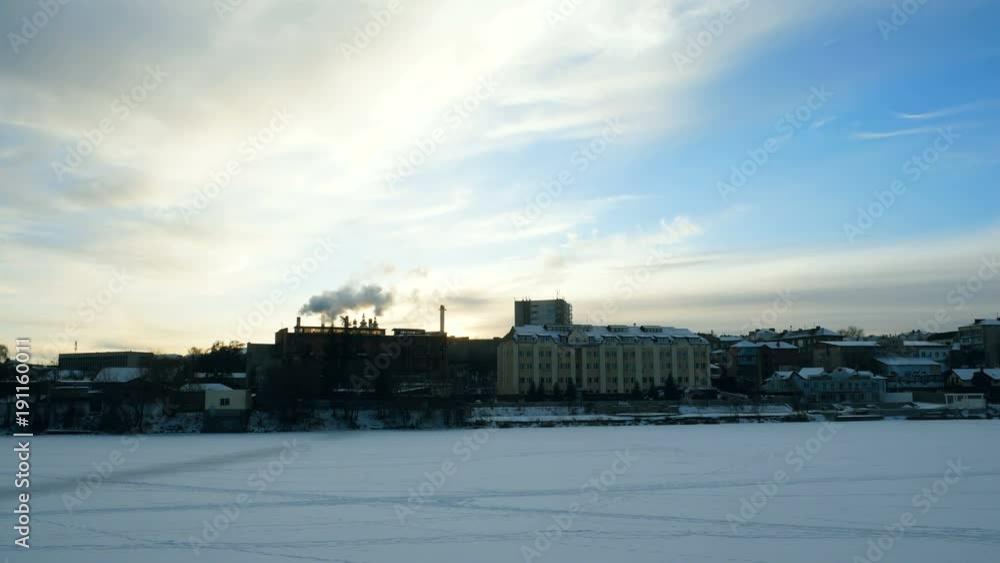 Panoramic video overlooking the winter city on the river. From the chimney of the plant comes thick smoke. Panoramic video overlooking the winter city on the river. From the chimney of the plant comes thick smoke.
