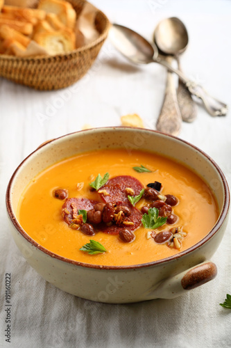 Hot pumpkin cream soup with beans and chorizo