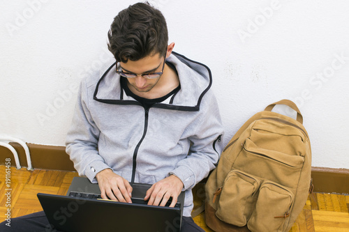 student with the computer and backpack of the college or university