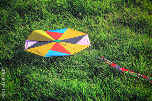 Fallen colourful kite on grass