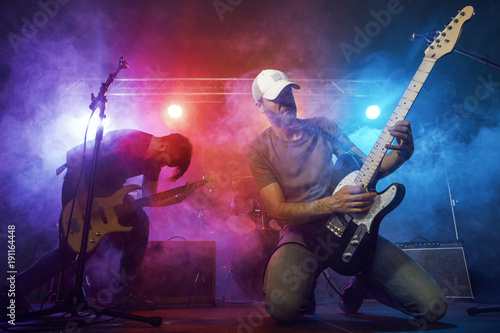 Guitarist and bass player perform on stage.