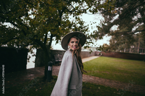 attractive smiling girl in stylish jacket and hat