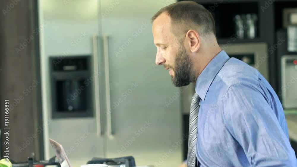 Young businessman drinking coffee at home
Young businessman drinking coffee at home