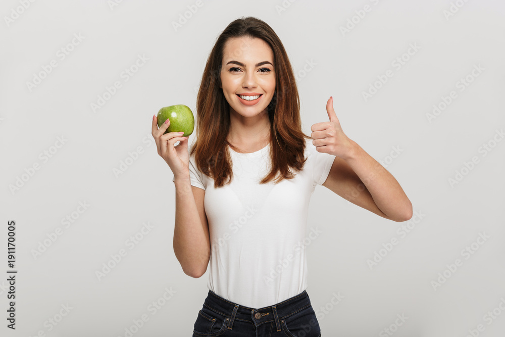 Portrait of a healthy young woman holding green apple Portrait of a healthy young woman holding green apple