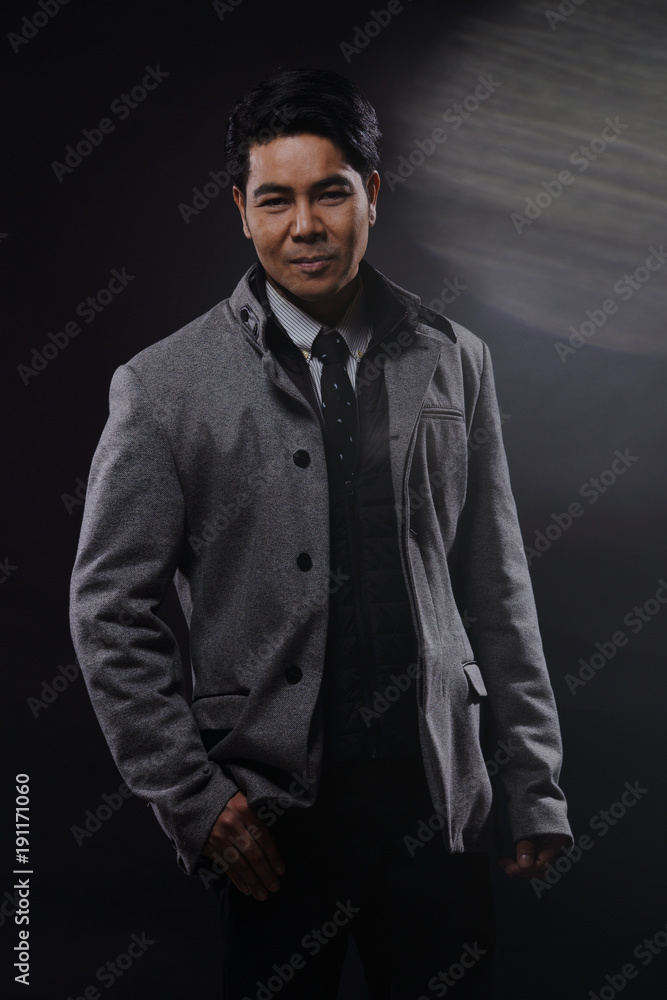 Portrait half body, Business Man Stand in gray coat white shirt black pants, studio