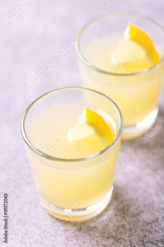 Italian lemon lime liqueur limoncello with ice and mint
