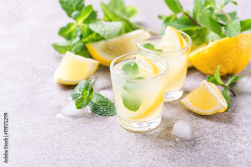 Italian lemon lime liqueur limoncello with ice and mint photo