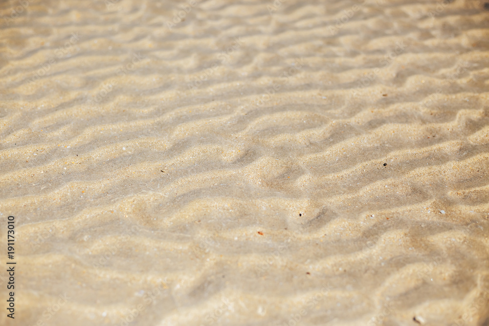 Fototapeta premium Figure in the form of curved lines in the sand on the beach, make waves