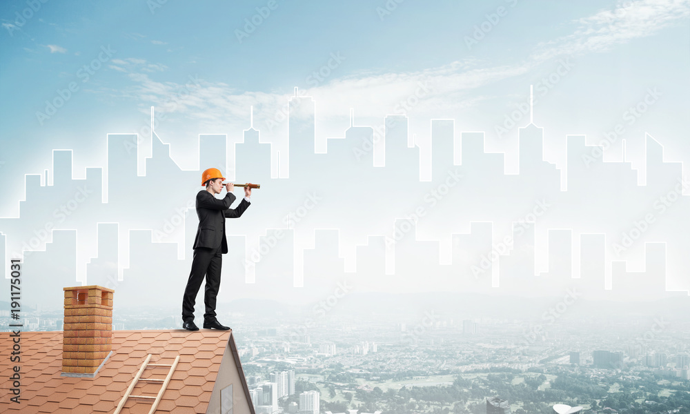 Engineer man standing on roof and looking in spyglass. Mixed media Engineer man standing on roof and looking in spyglass. Mixed media