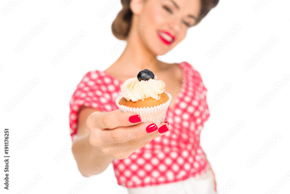 selective focus of woman in pin up clothing showing cupcake isolated on white selective focus of woman in pin up clothing showing cupcake isolated on white