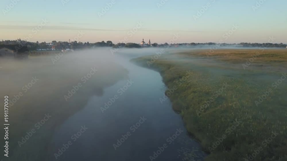 Aerial view of the fog over the river at dawn Aerial view of the fog over the river at dawn