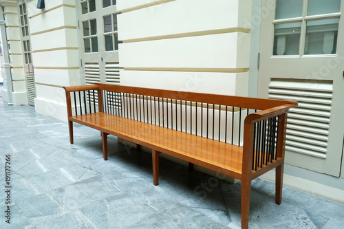 Wooden bench in front of a wall