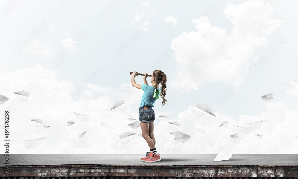 Concept of careless happy childhood with girl exploring this wor Concept of careless happy childhood with girl exploring this wor