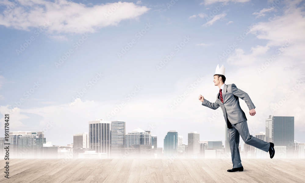 King businessman in elegant suit running and modern cityscape at King businessman in elegant suit running and modern cityscape at