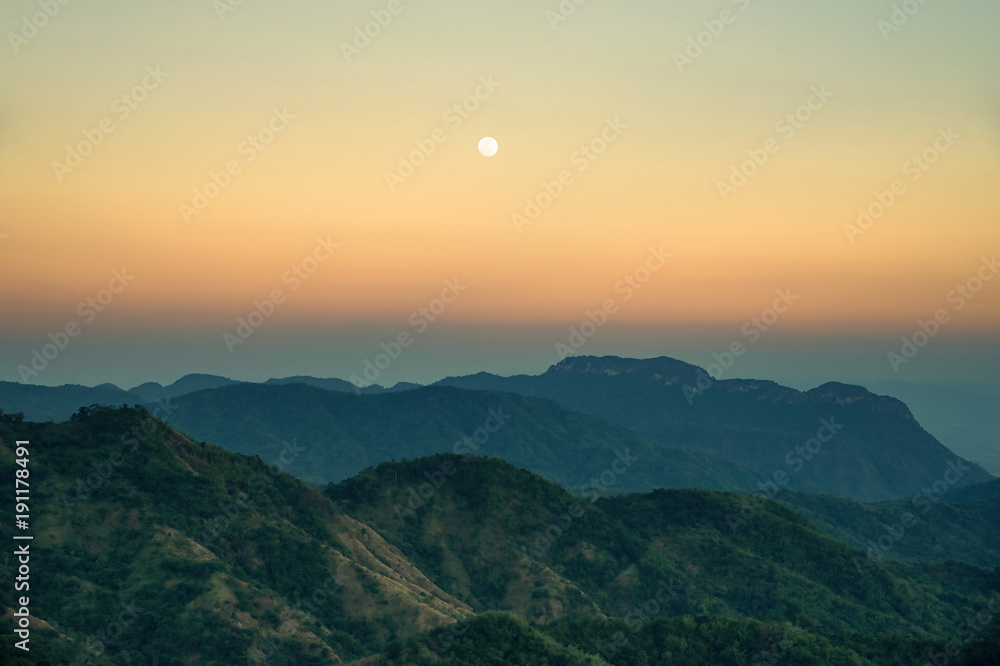 Fototapeta premium Moon rises on mountain after sunset : Thailand