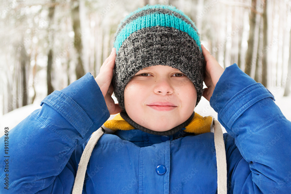 little boy in the winter forest. portrait of a boy in a hat little boy in the winter forest. portrait of a boy in a hat