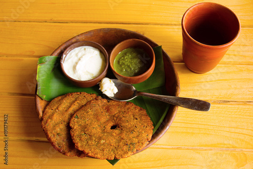 Top view of thalipith popular Maharashtrian savory pancakes with curd and pudina Chutney photo