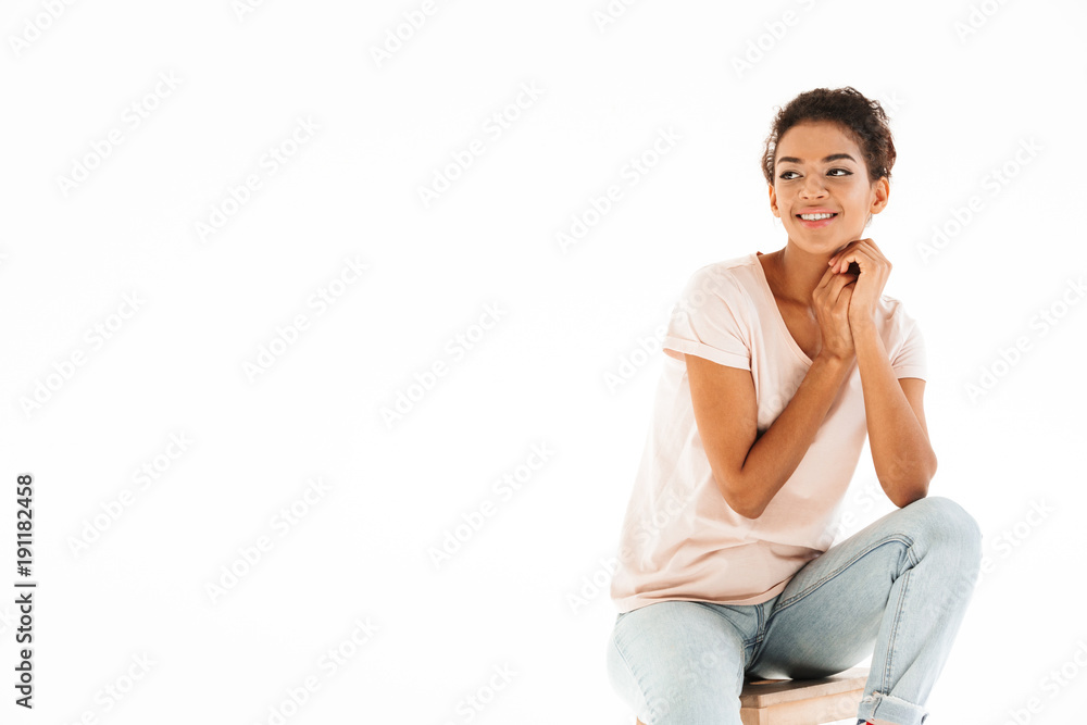 Portrait of beautiful woman sitting on chair and looking aside on copyspace with smile, isolated over white background Portrait of beautiful woman sitting on chair and looking aside on copyspace with smile, isolated over white background