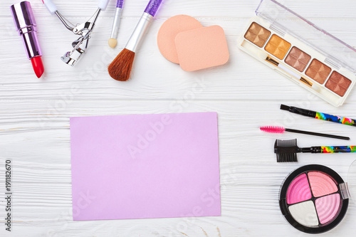 Makeup cosmetics and equipment. Blank paper sheet. Work space of visagiste.