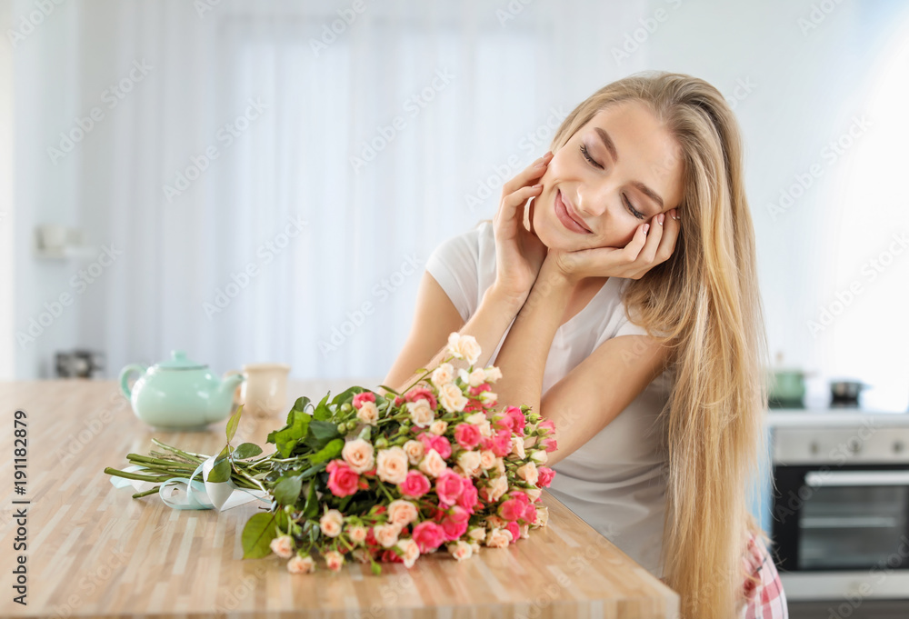 Beautiful young woman with bouquet of roses at home Beautiful young woman with bouquet of roses at home