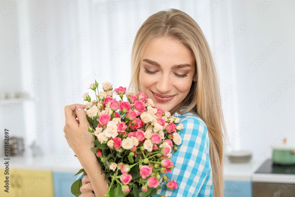Beautiful young woman with bouquet of roses at home Beautiful young woman with bouquet of roses at home