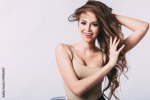 Woman. Portrait of young smiling girl with long healthy hair.
