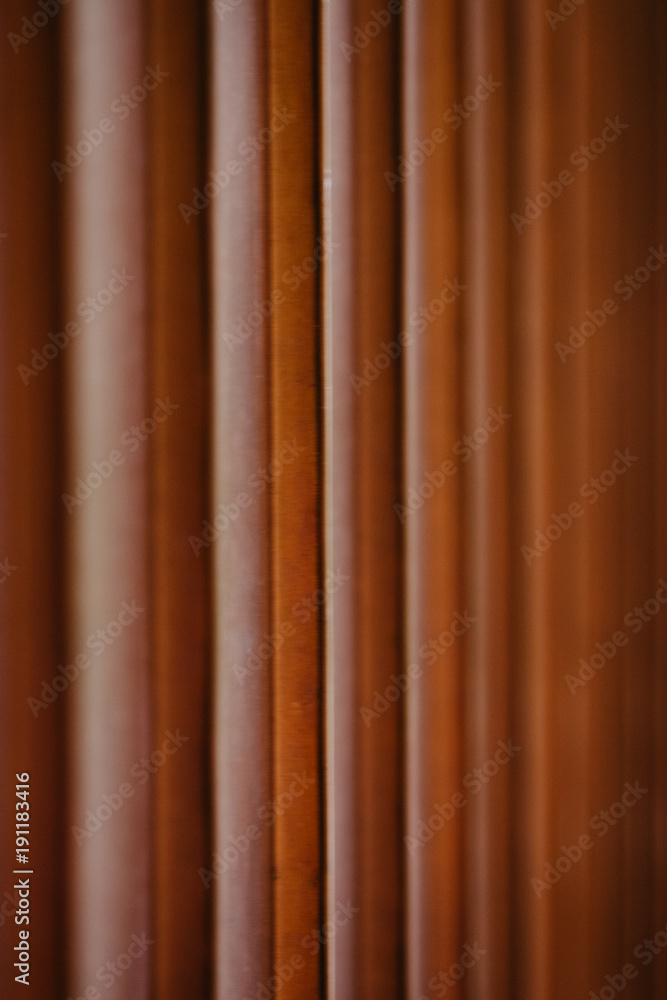 Copper material as a wall decoration for house exterior, a fragment of vertical lines going down Copper material as a wall decoration for house exterior, a fragment of vertical lines going down