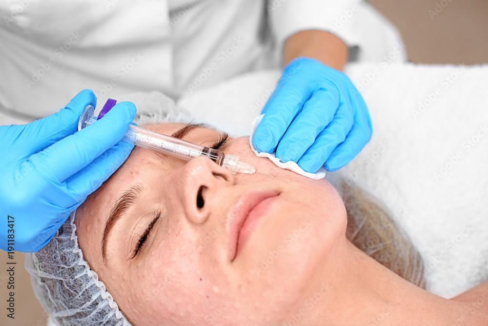 Beautician making injection in woman's face, closeup. Biorevitalization procedure Beautician making injection in woman's face, closeup. Biorevitalization procedure