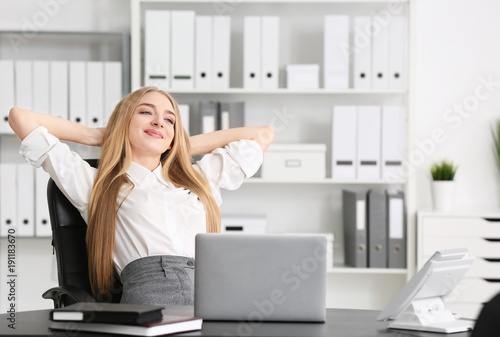 Young businesswoman relaxing in office