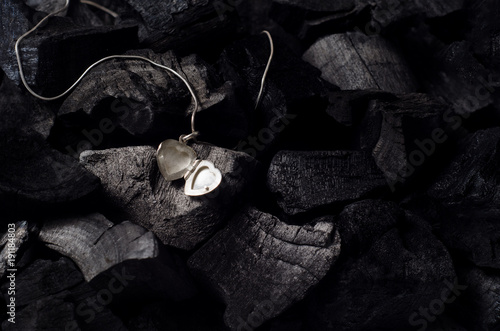 Wallpaper Mural Silver heart  shape locket with necklace on black charcoal texture background Torontodigital.ca