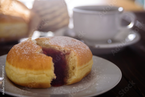 Berliner donut with berry jam. Close up