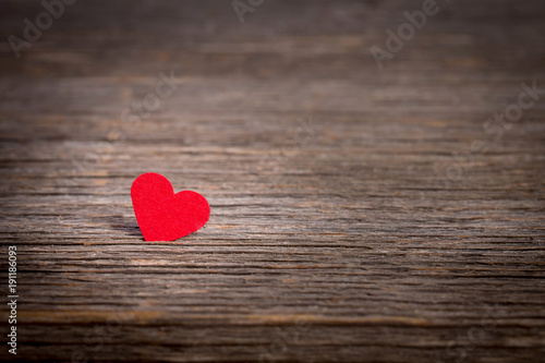 Red heart on old wooden background